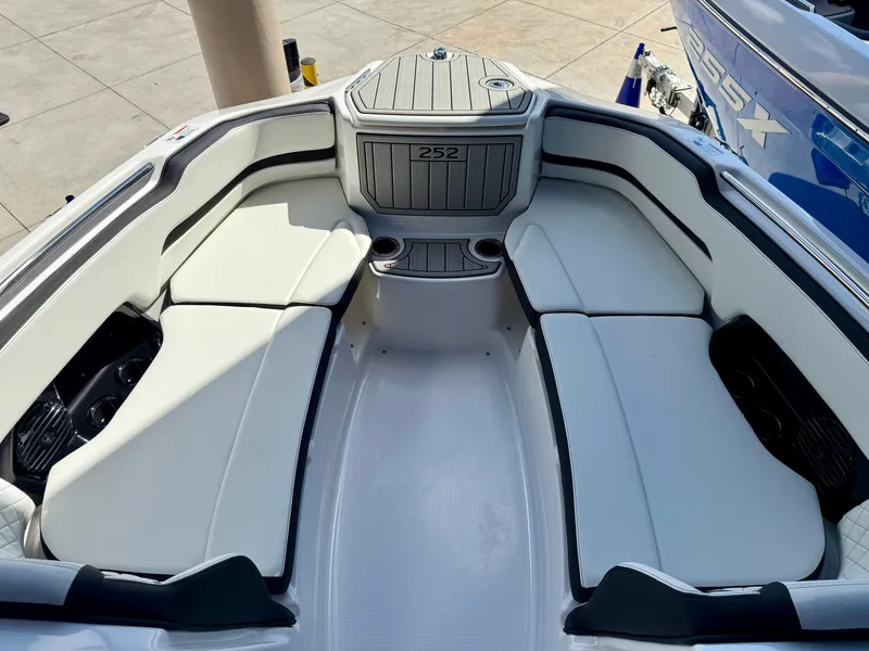 Slide: The Image of 2025 Yamaha Boats 252SD interior with white seating and cup holders. - 10