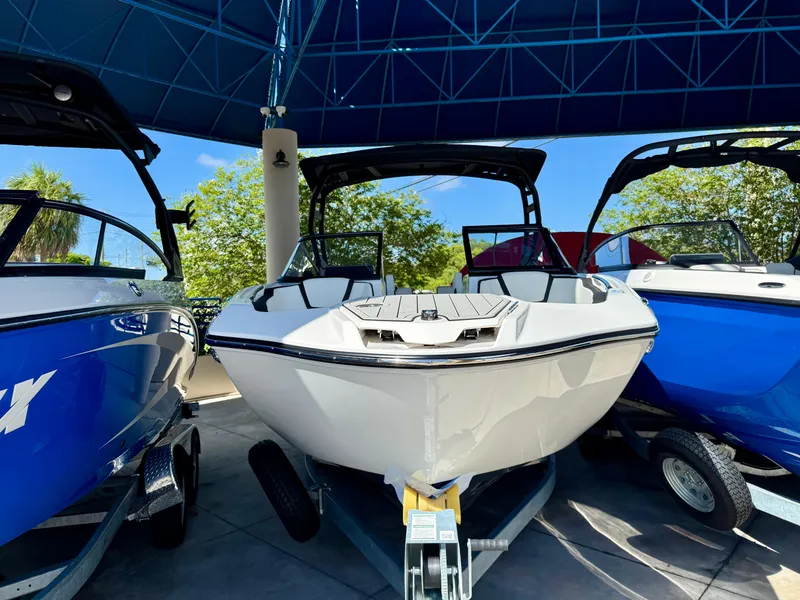 Slide: The Image of 2025 Yamaha Boats 252SD displayed under a canopy, flanked by other boats. - 4