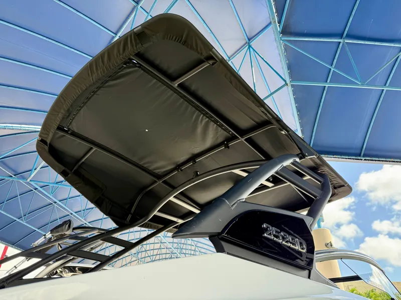 Slide: The Image of 2025 Yamaha Boats 252SD with sleek canopy under blue sky. - 7