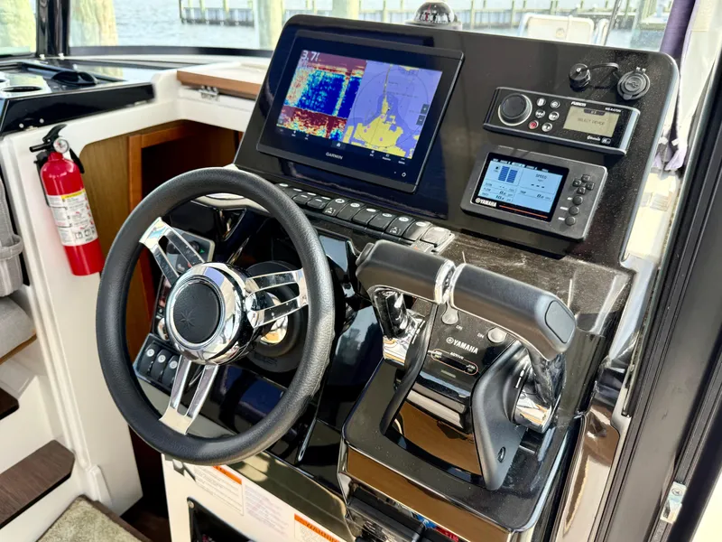Slide: The Image of Helm of 2020 Jeanneau NC Sport 895 with navigation and control systems. - 24