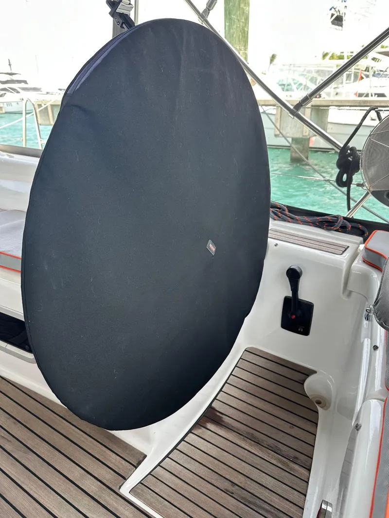 Slide: The Image of Beneteau Oceanis 50 yacht helm with cover, 2014 model, docked with wooden deck. - 15