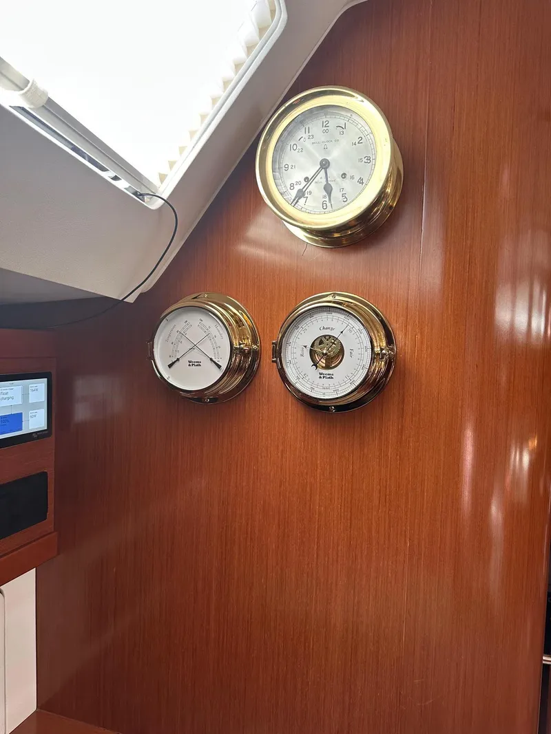 Slide: The Image of Interior of 2014 Beneteau Oceanis 50 yacht with brass instruments on wooden panel. - 19