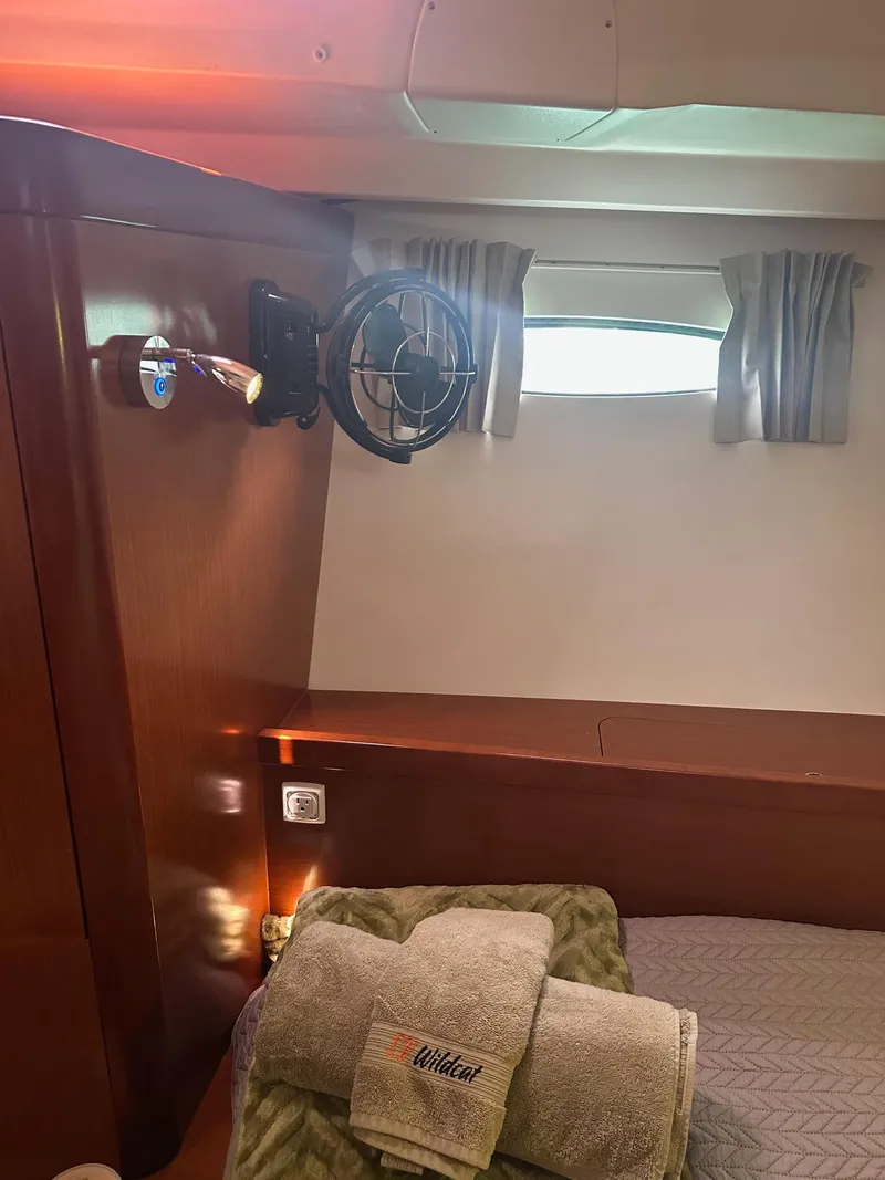 Slide: The Image of Interior cabin of 2014 Beneteau Oceanis 50 yacht with bed, fan, and window. - 25