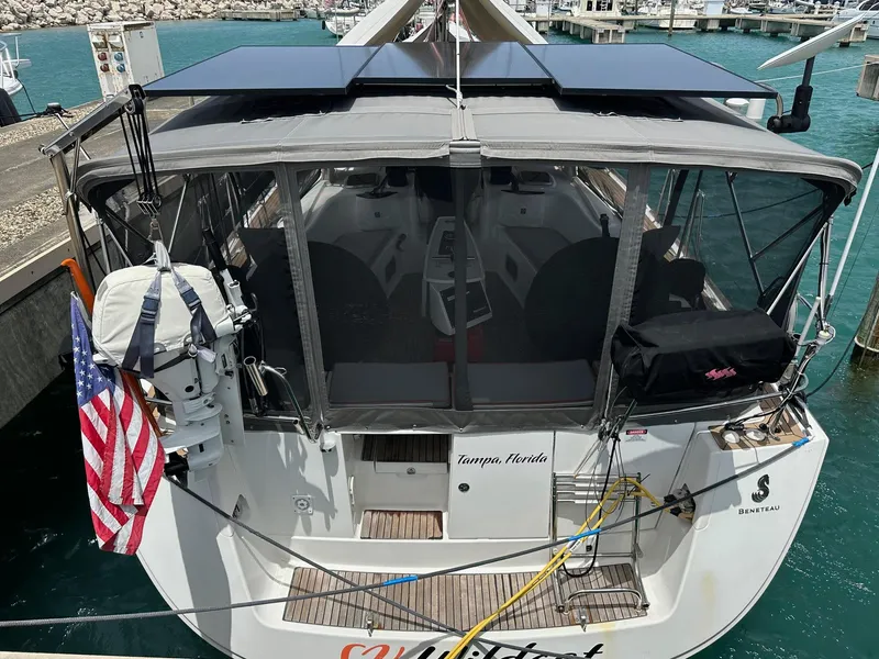 Slide: The Image of 2014 Beneteau Oceanis 50 docked, featuring solar panels and an American flag. - 3