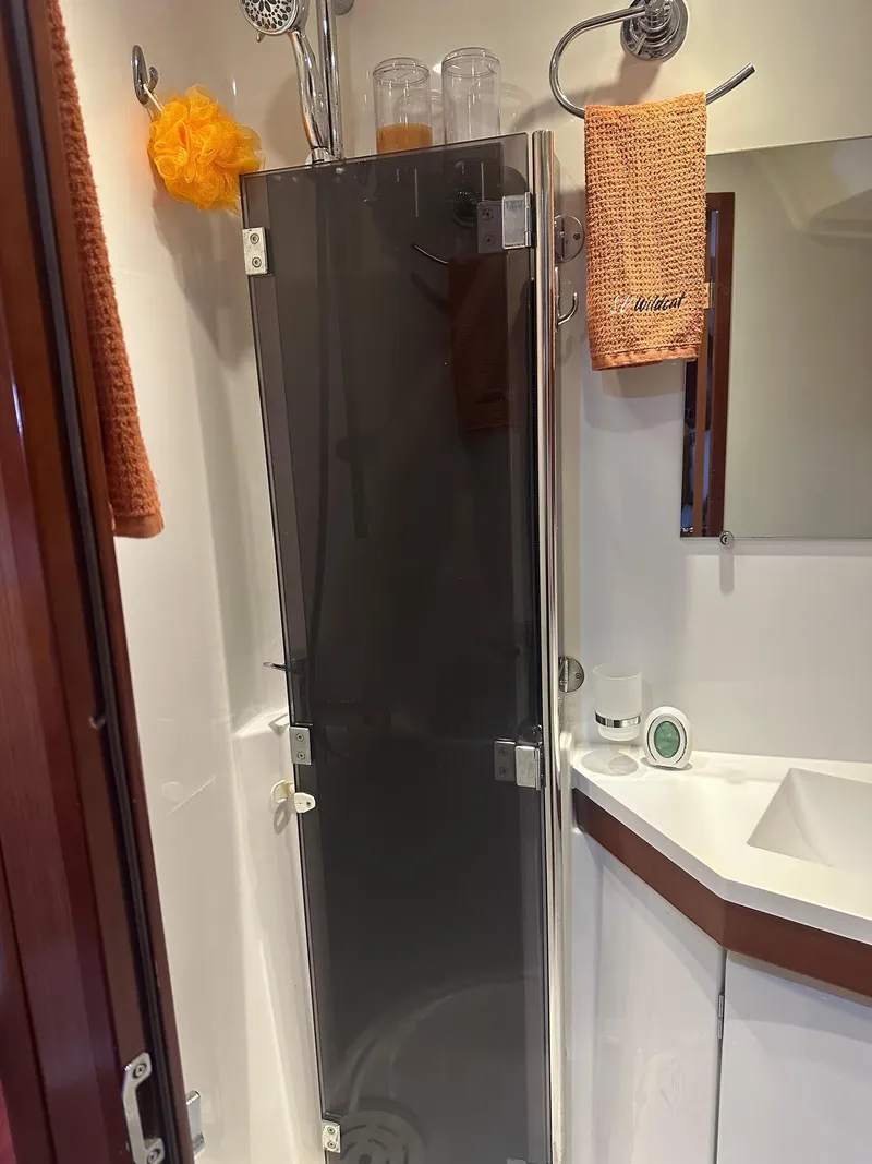 Slide: The Image of Beneteau Oceanis 50 bathroom with glass shower door, orange towels, and modern fixtures, 2014 model. - 33