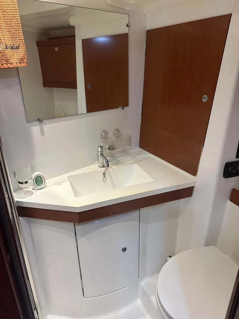 Slide: The Image of Beneteau Oceanis 50 bathroom, 2014 model, featuring a modern sink and mirror setup. - 44