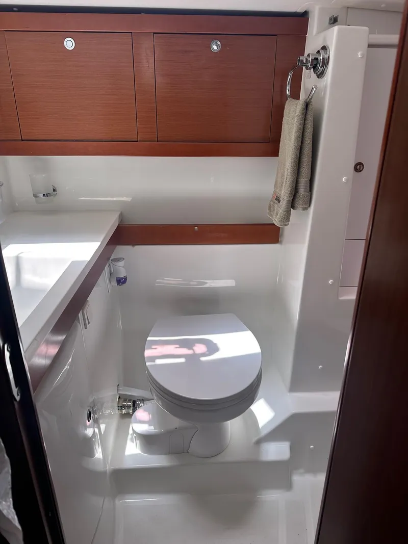 Slide: The Image of Bathroom interior of 2014 Beneteau Oceanis 50 yacht, featuring modern fixtures and wooden cabinetry. - 46