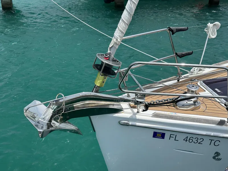 Slide: The Image of Beneteau Oceanis 50 sailboat bow with anchor, 2014 model, in turquoise water. - 5