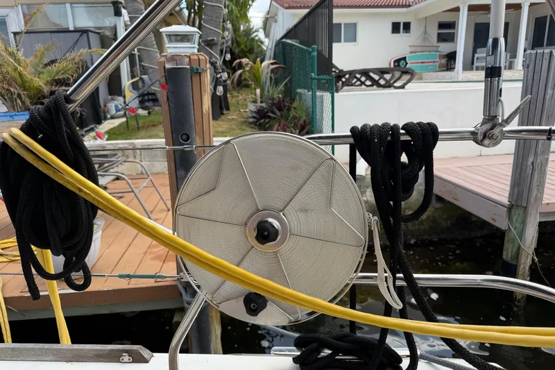 Slide: The Image of Coiled ropes on a Beneteau Oceanis 50 sailboat, docked near a residential area. - 64