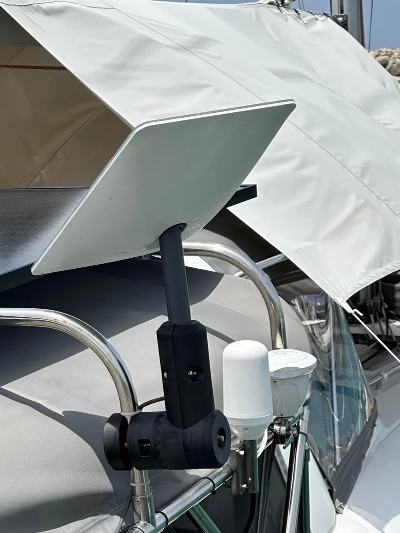 Slide: The Image of Satellite dish mounted on a 2014 Beneteau Oceanis 50 sailboat, under a white canopy. - 9