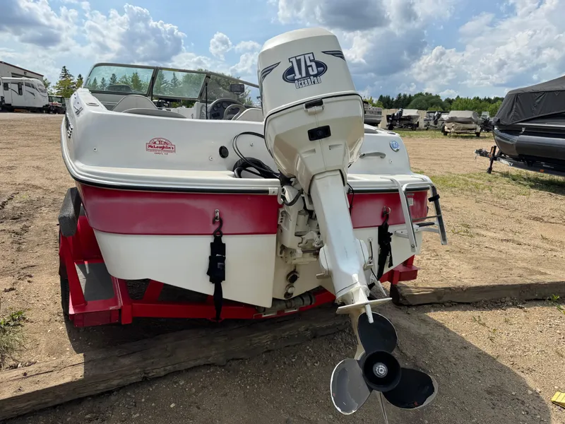 Slide: The Image of 2000 Four Winns 180 Horizon boat with outboard motor in a garage setting. - 4