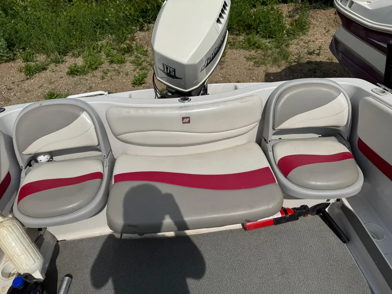 Slide: The Image of 2000 Four Winns 180 Horizon boat interior with steering wheel and seating. - 6