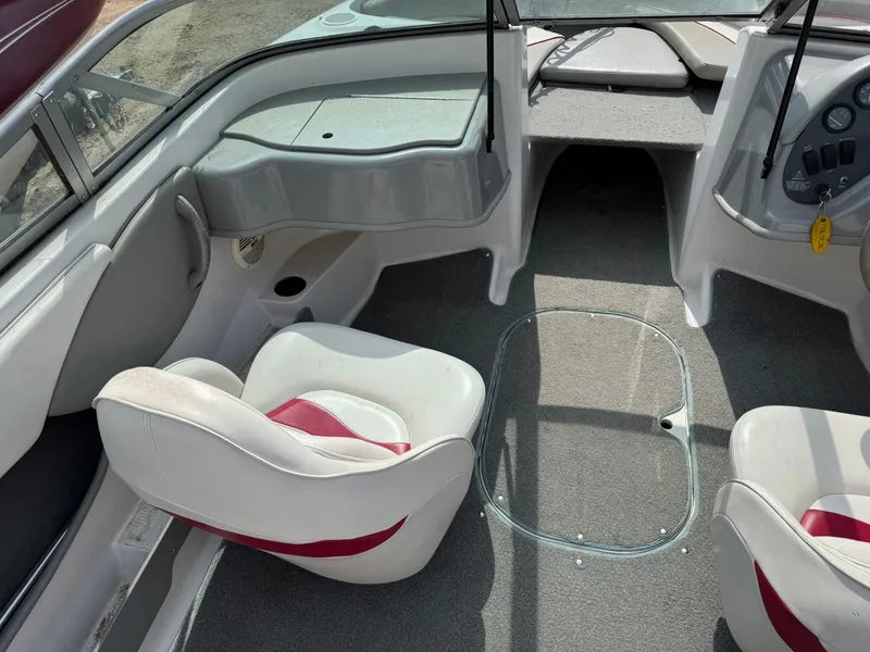 Slide: The Image of 2000 Four Winns 180 Horizon capacity and safety warning labels on boat interior. - 8