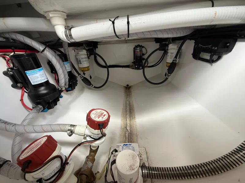 Slide: The Image of 2024 Carrera Powerboats 320CC Classic engine compartment with hoses and filters. - 11