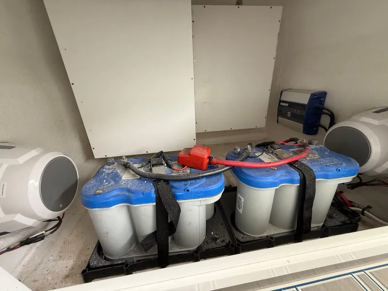 Slide: The Image of 2024 Carrera Powerboats 320CC Classic battery compartment with dual batteries and wiring. - 12