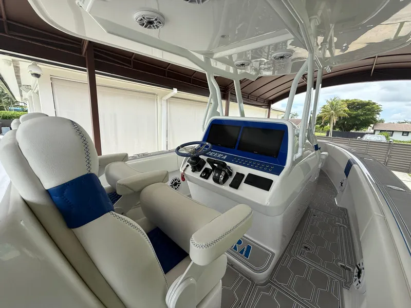 Slide: The Image of 2024 Carrera Powerboats 320CC Classic interior with modern helm and seating. - 14