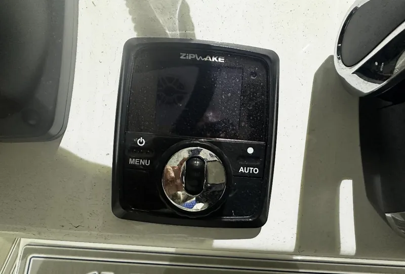 Slide: The Image of 2024 Carrera Powerboats 320CC Classic dashboard with Zipwake control panel. - 15