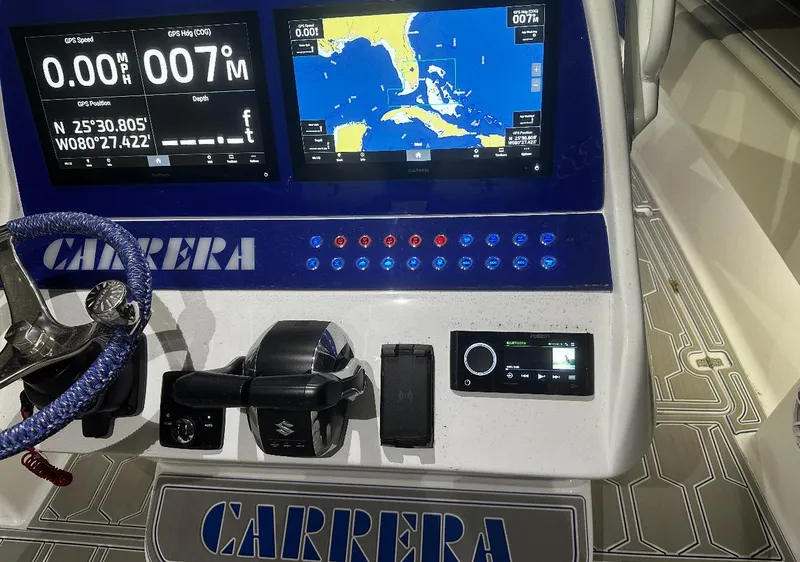 Slide: The Image of 2024 Carrera Powerboats 320CC Classic dashboard with navigation screens and controls. - 19