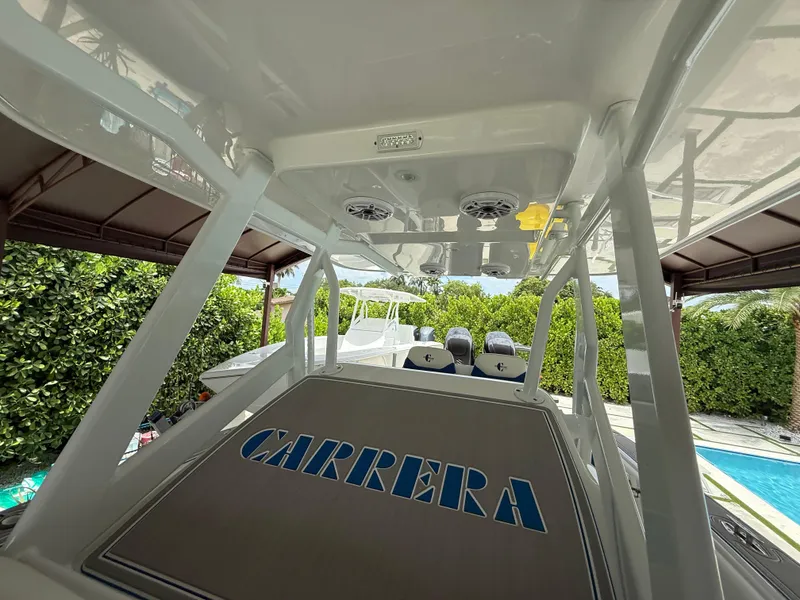 Slide: The Image of 2024 Carrera Powerboats 320CC Classic, showcasing sleek design and spacious deck area. - 21