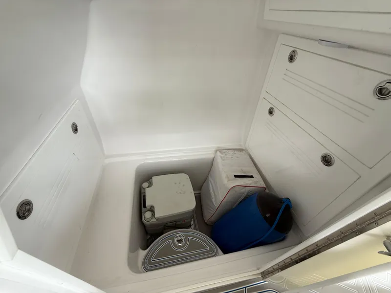 Slide: The Image of 2024 Carrera Powerboats 320CC Classic storage compartment with various items inside. - 22