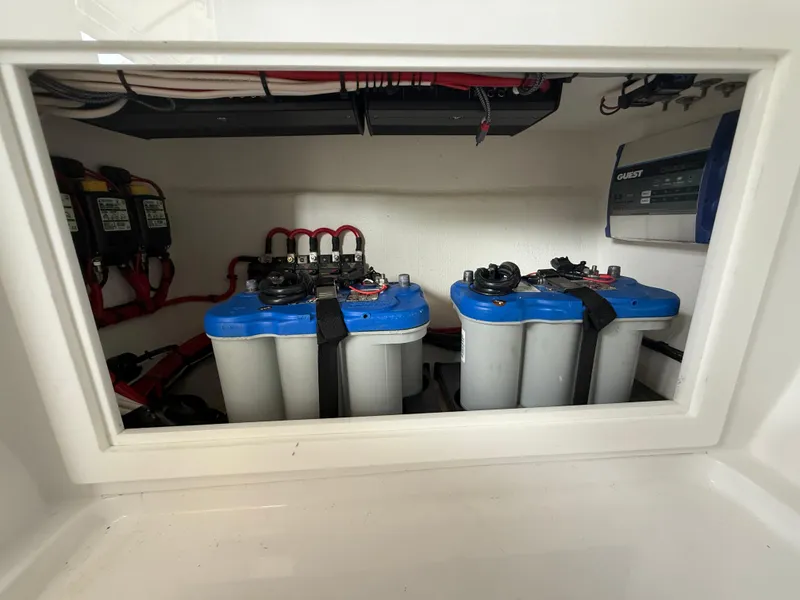 Slide: The Image of Battery compartment of 2024 Carrera Powerboats 320CC Classic, featuring dual marine batteries. - 25