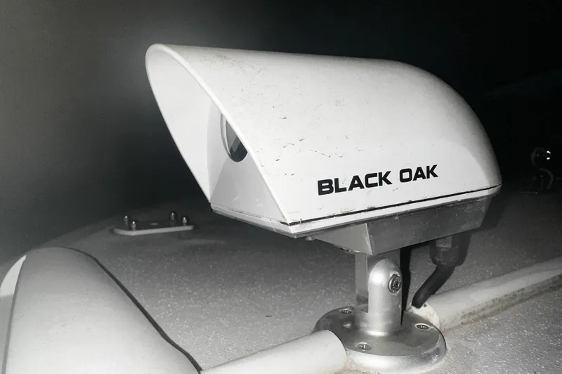 Slide: The Image of 2024 Carrera Powerboats 320CC Classic with Black Oak light fixture, close-up view. - 28