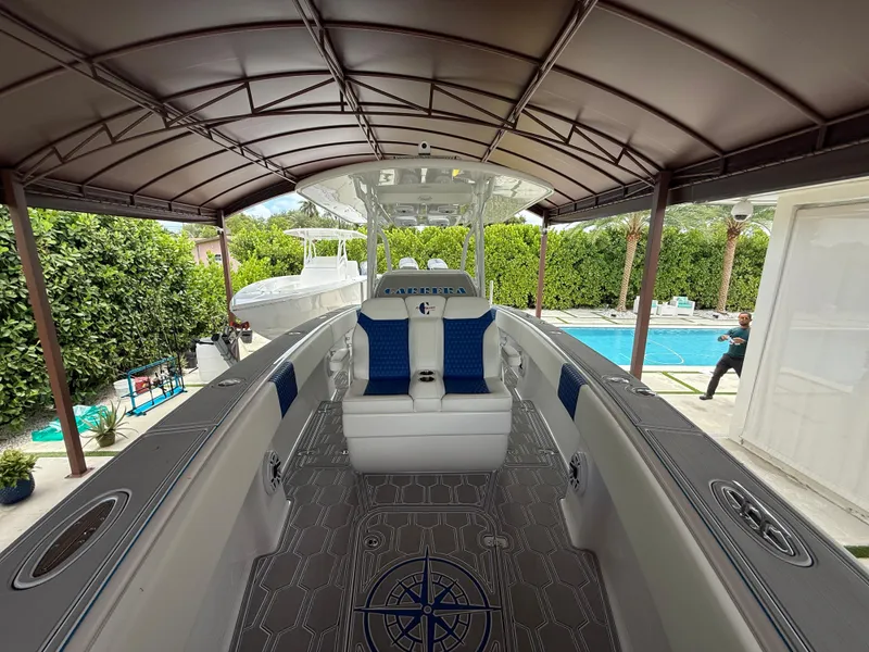 Slide: The Image of 2024 Carrera Powerboats 320CC Classic interior under canopy, near poolside setting. - 32
