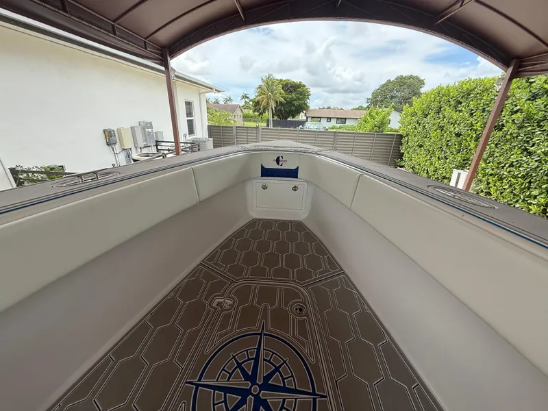 Slide: The Image of 2024 Carrera Powerboats 320CC Classic interior with sleek design and compass-themed flooring. - 33