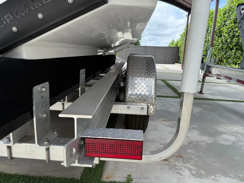 Slide: The Image of Trailer detail of 2024 Carrera Powerboats 320CC Classic, featuring metal frame and red reflector. - 42