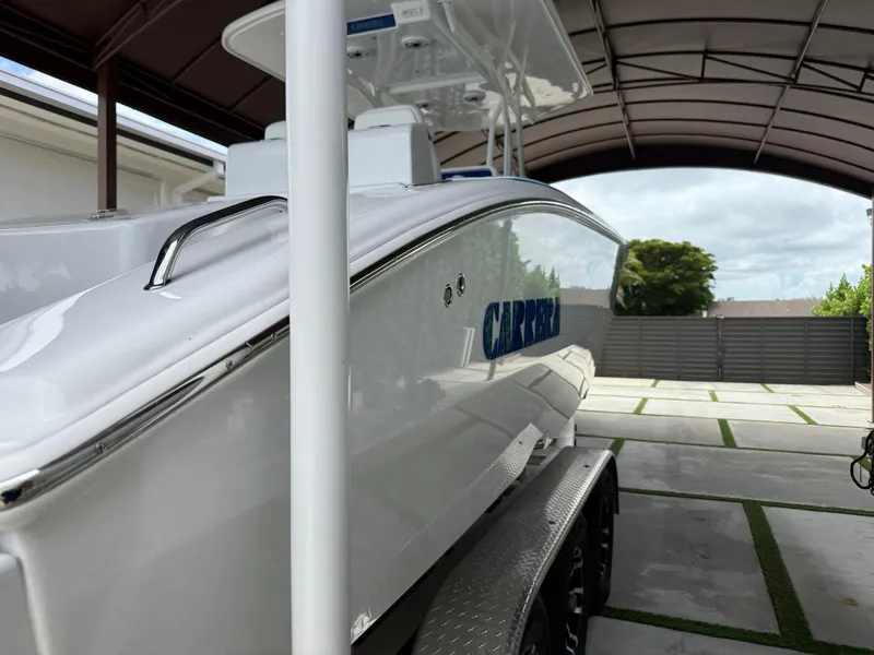 Slide: The Image of 2024 Carrera Powerboats 320CC Classic under a canopy, showcasing sleek design and modern features. - 43