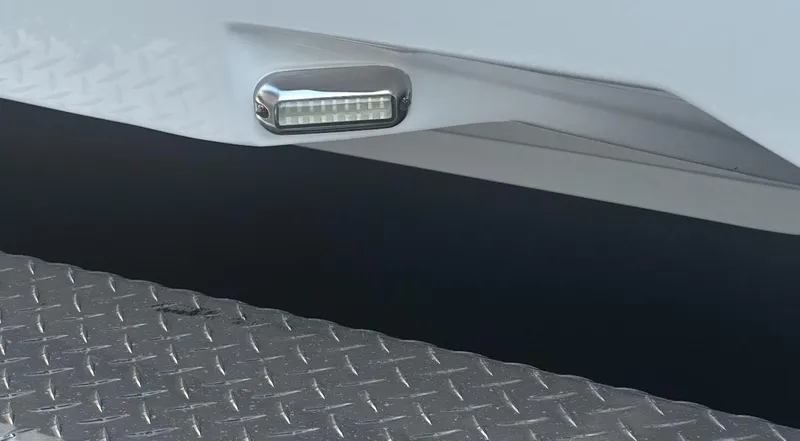 Slide: The Image of 2024 Carrera Powerboats 320CC Classic hull detail with LED light and textured surface. - 44