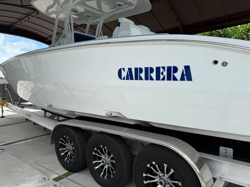 Slide: The Image of 2024 Carrera Powerboats 320CC Classic on trailer, under shelter, side view. - 48