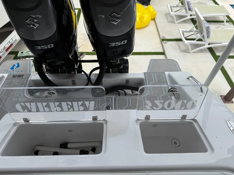 Slide: The Image of 2024 Carrera Powerboats 320CC Classic with dual Suzuki 350 engines, rear deck view. - 5