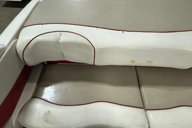 Slide: The Image of Worn beige and red boat seat from a 1998 Larson 195 model. - 11