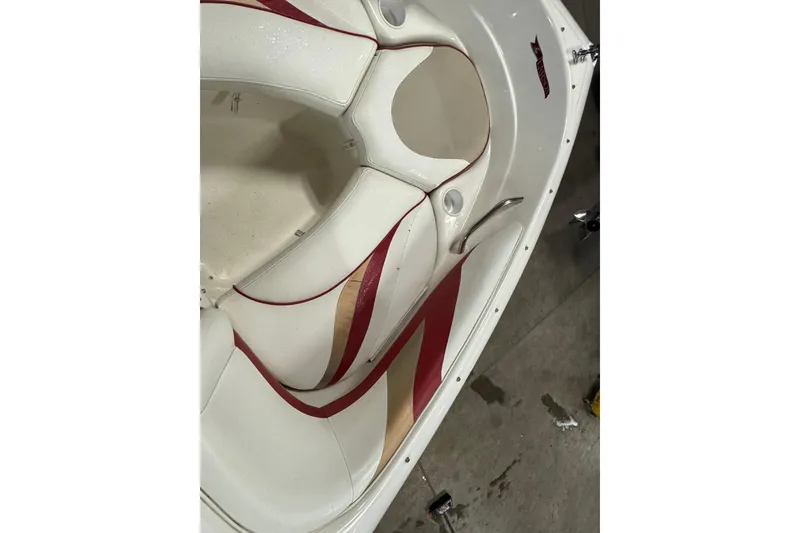 Slide: The Image of Interior of a 1998 Larson 195 boat with white and red seating. - 15