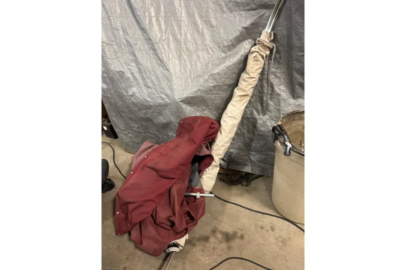 Slide: The Image of Covered Larson 195 boat part, 1998 model, in a garage setting. - 19