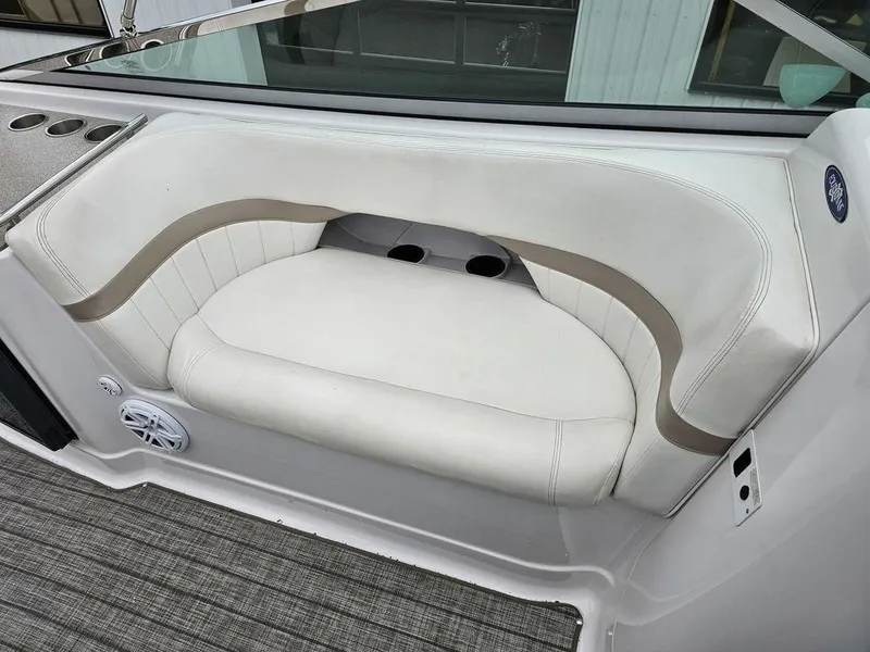 Slide: The Image of 2006 Four Winns 290 Horizon boat interior with white cushioned seating and cup holders. - 11
