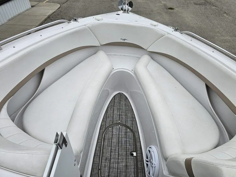 Slide: The Image of 2006 Four Winns 290 Horizon boat interior with white cushioned seating and carpeted floor. - 13