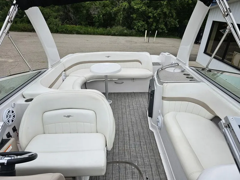 Slide: The Image of 2006 Four Winns 290 Horizon boat interior with white seating and a small table. - 14