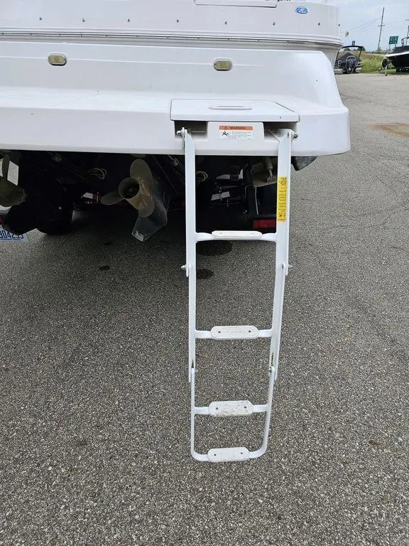 Slide: The Image of Rear view of 2006 Four Winns 290 Horizon boat with extended swim ladder. - 17