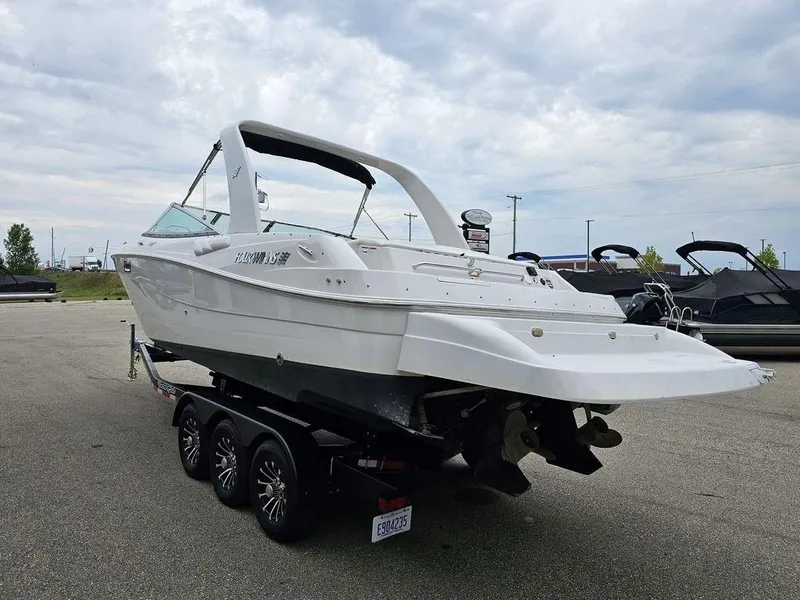 Slide: The Image of 2006 Four Winns 290 Horizon boat on trailer, parked outdoors under cloudy sky. - 4