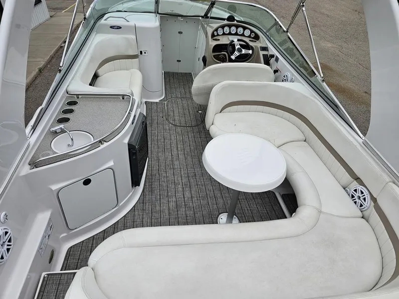 Slide: The Image of 2006 Four Winns 290 Horizon boat interior with seating, table, and helm. - 6