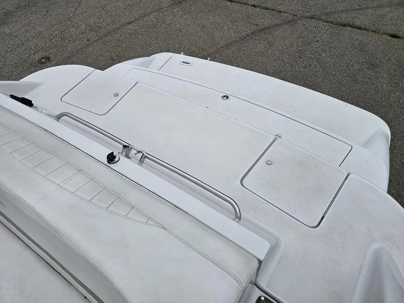 Slide: The Image of 2006 Four Winns 290 Horizon boat deck with white seating and storage compartments. - 7