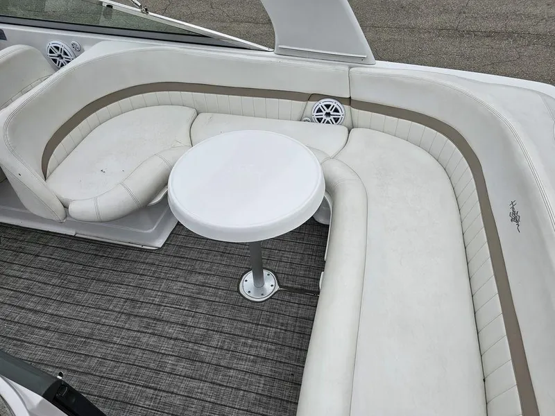 Slide: The Image of 2006 Four Winns 290 Horizon boat interior with white seating and round table. - 8