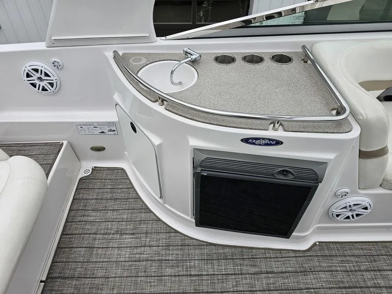 Slide: The Image of 2006 Four Winns 290 Horizon boat interior with sink, cup holders, and seating area. - 9