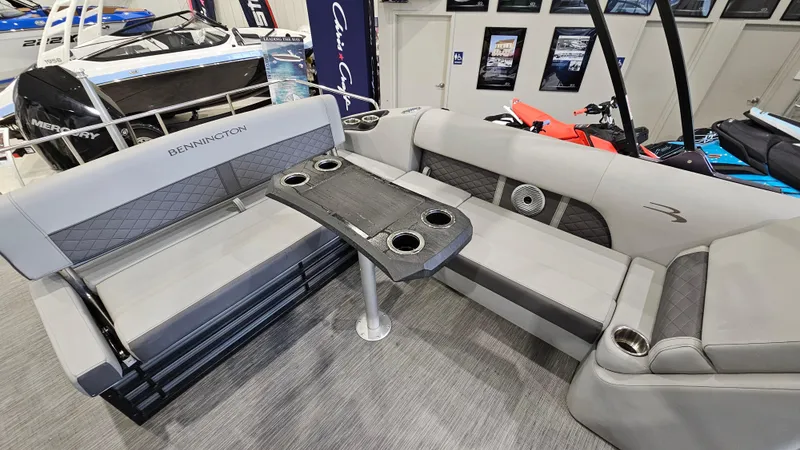 Slide: The Image of 2020 Bennington L 25 Swingback boat interior with gray seating and table. - 10