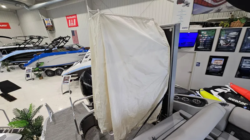 Slide: The Image of Bennington L 25 Swingback 2020 boat interior with privacy curtain in showroom. - 18