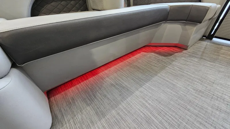 Slide: The Image of 2020 Bennington L 25 Swingback interior with red LED lighting and gray upholstery. - 20