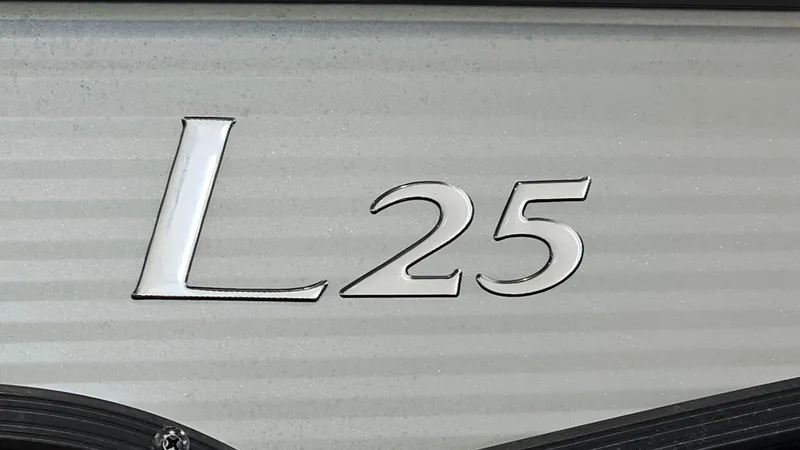Slide: The Image of 2020 Bennington L 25 Swingback logo on boat exterior. - 22