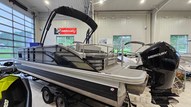 Slide: The Image of 2020 Bennington L 25 Swingback pontoon boat in showroom with Mercury engine. - 3